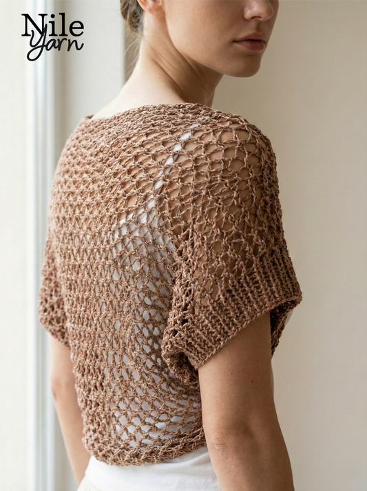 Woman wearing a brown knitted shrug with 'Nile Yarn' branding.