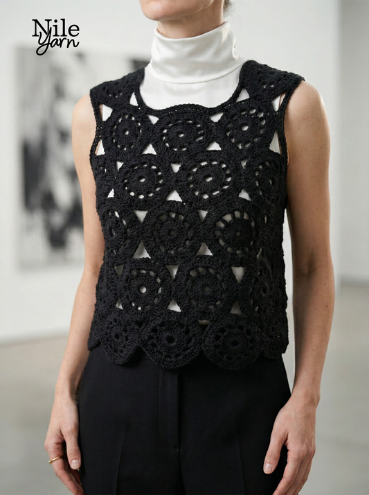 Front view of a model wearing the black Eclipse Circles crochet top over a white turtleneck, featuring geometric circular motifs and a scalloped hem